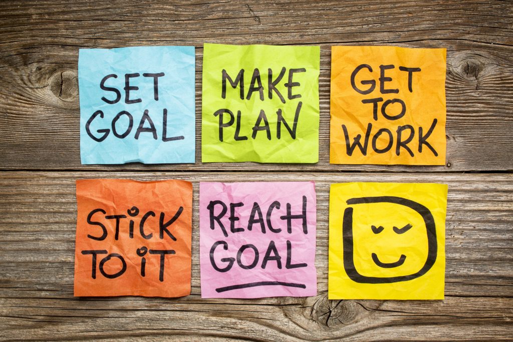 colored sticky notes that say motivational statements about goals